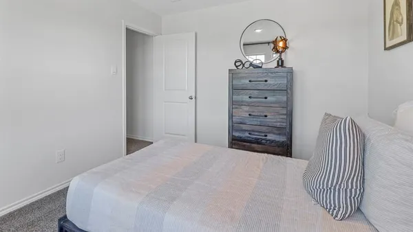 a bedroom with a bed and a dresser