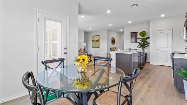 a dining room with furniture and window