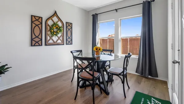 a view of a dining room with furniture and wooden floor