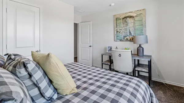 a large bed sitting in a bedroom next to a window
