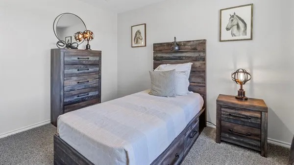 a bedroom with a bed and glass window