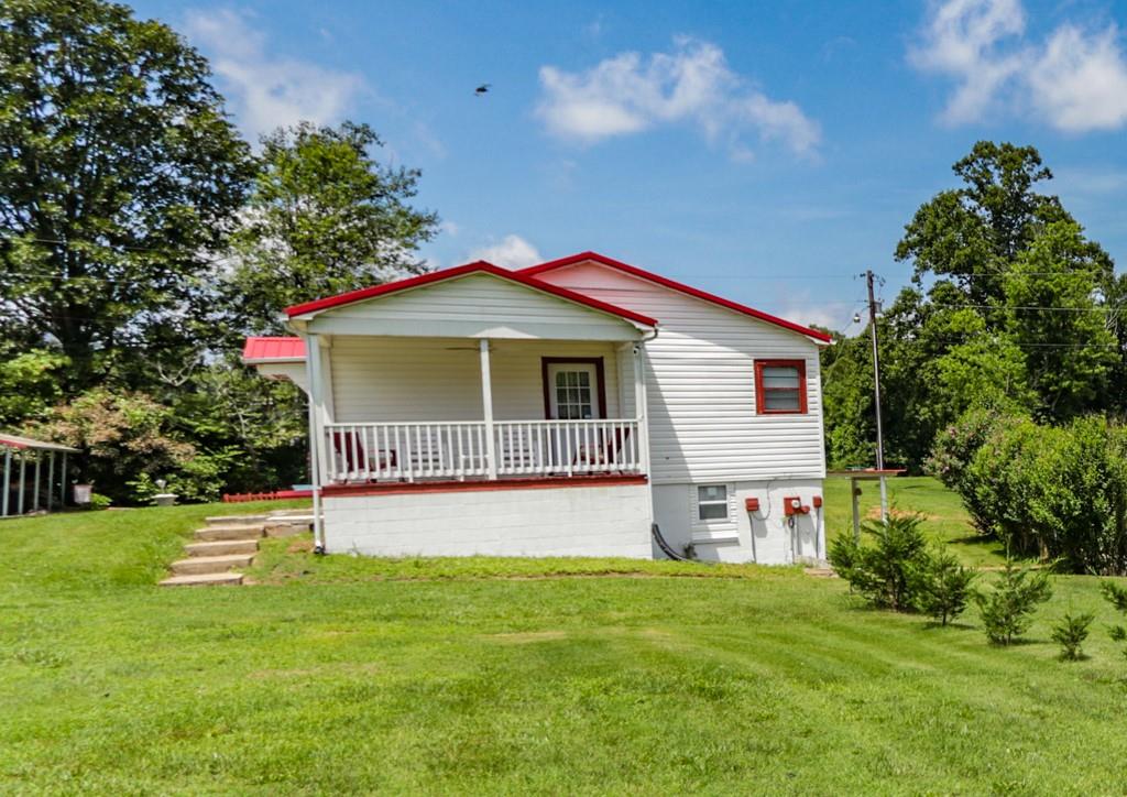 3015 Deal Mill Road Hudson, NC 28638 - Photo 11 of 34 a view of a house with a backyard and a tree