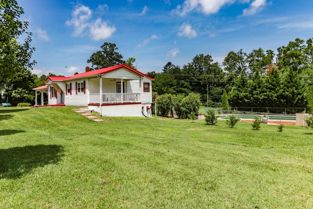 3015 Deal Mill Road Hudson, NC 28638 - Photo 12 of 34 a front view of a house with a yard