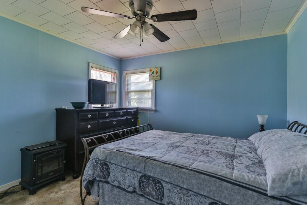 3015 Deal Mill Road Hudson, NC 28638 - Photo 23 of 34 a bedroom with a bed and a chandelier