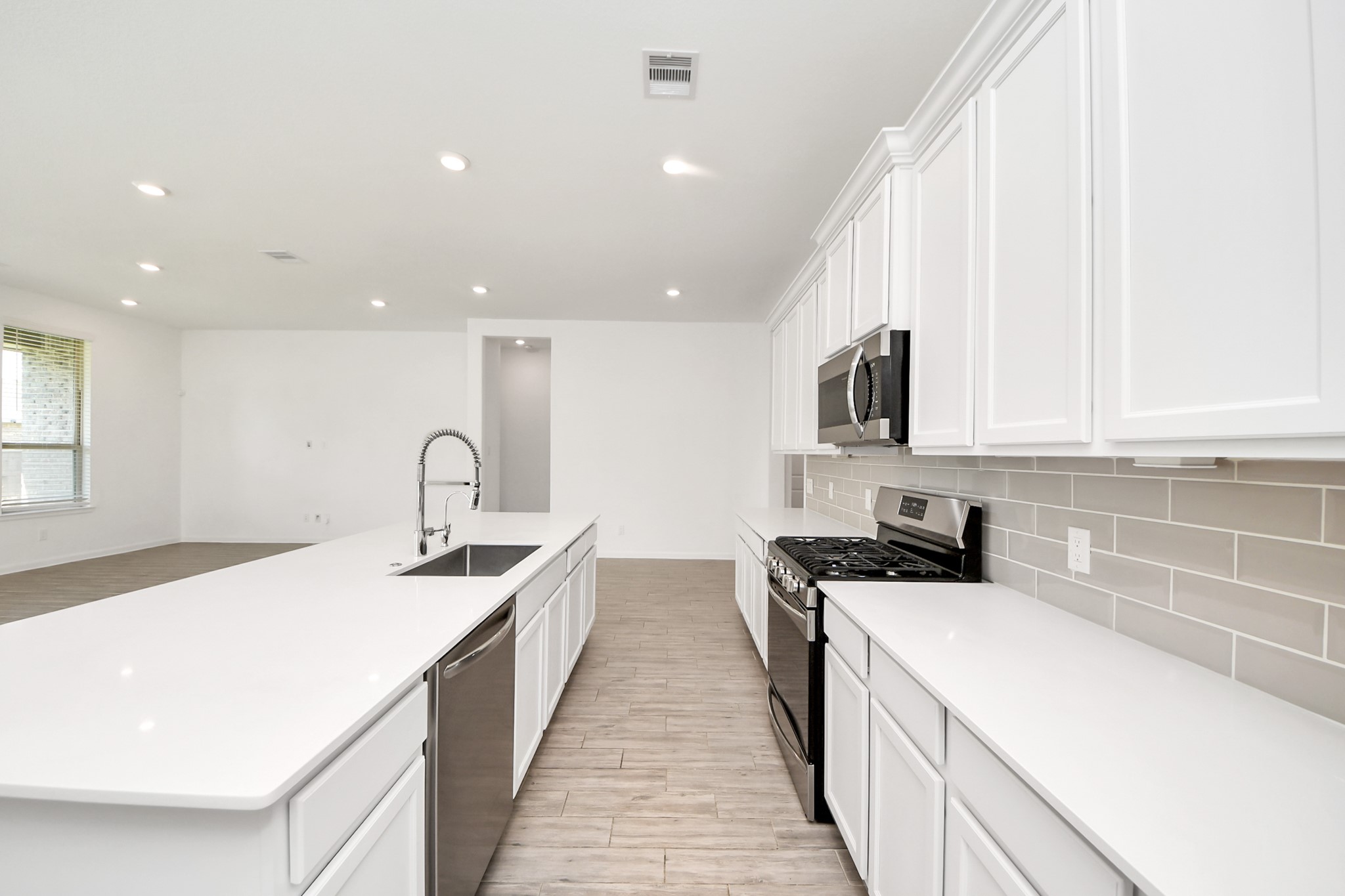 17770 Misty Brook Lane Conroe, TX 77302 - Photo 12 of 50 a kitchen with sink a microwave and stove