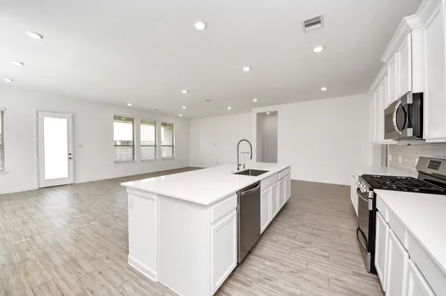 a kitchen with sink a microwave and stove