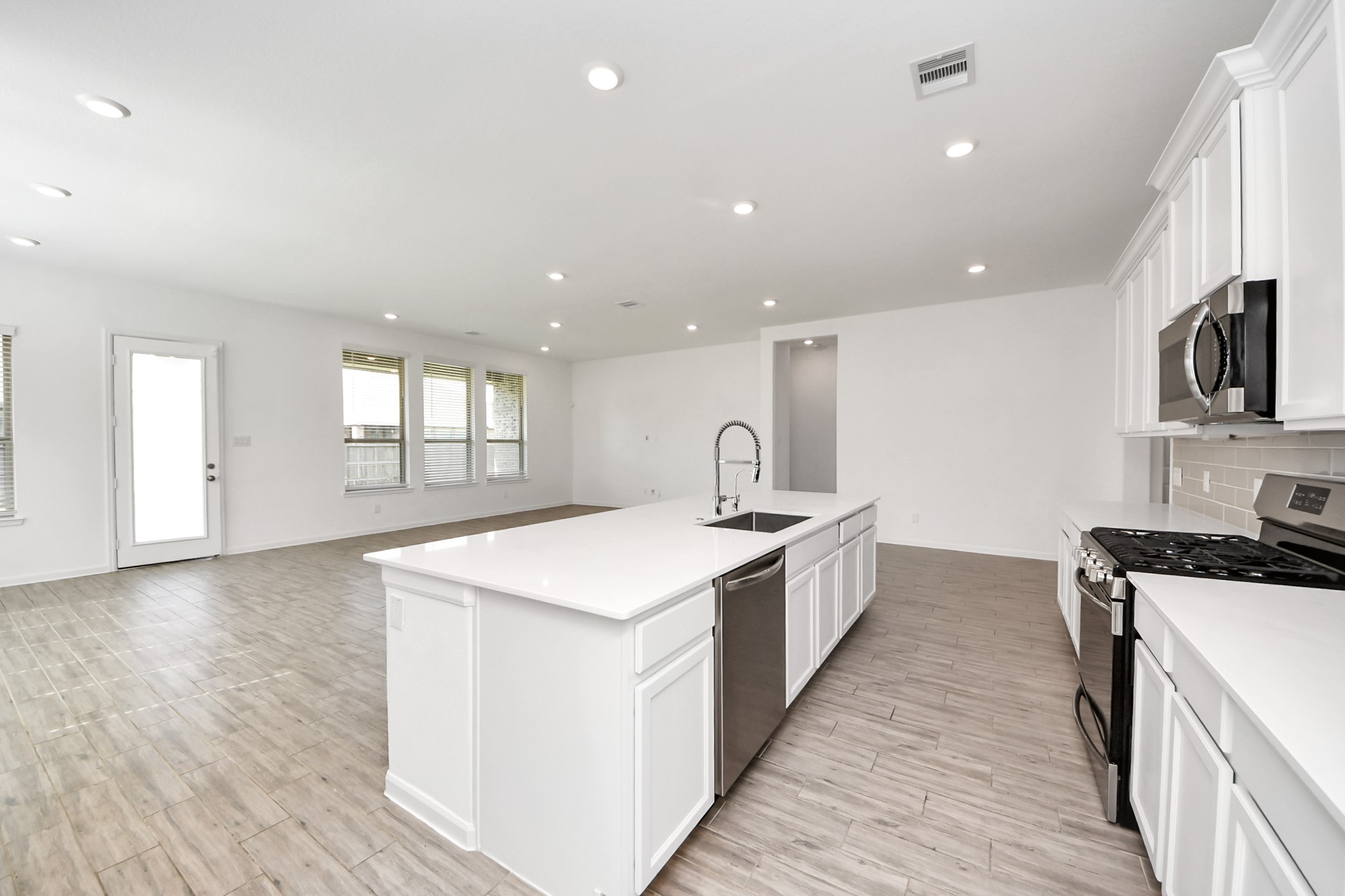 17770 Misty Brook Lane Conroe, TX 77302 - Photo 13 of 50 a large kitchen with stainless steel appliances granite countertop a stove a sink and a refrigerator