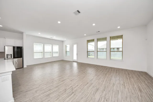 a view of kitchen with kitchen island and stainless steel appliances