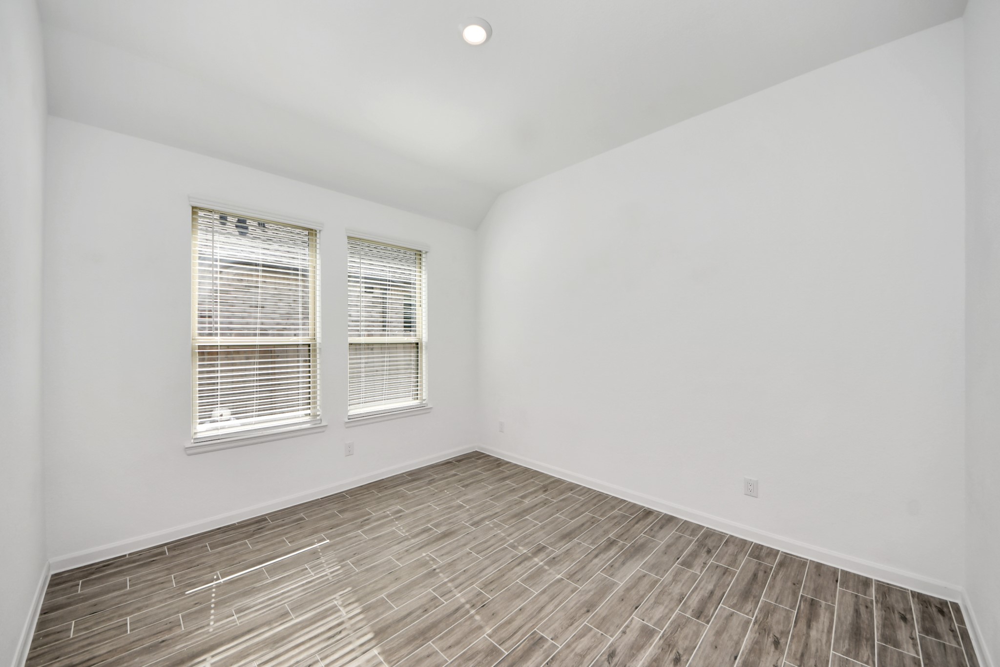17770 Misty Brook Lane Conroe, TX 77302 - Photo 19 of 50 a view of an empty room with wooden floor and a window