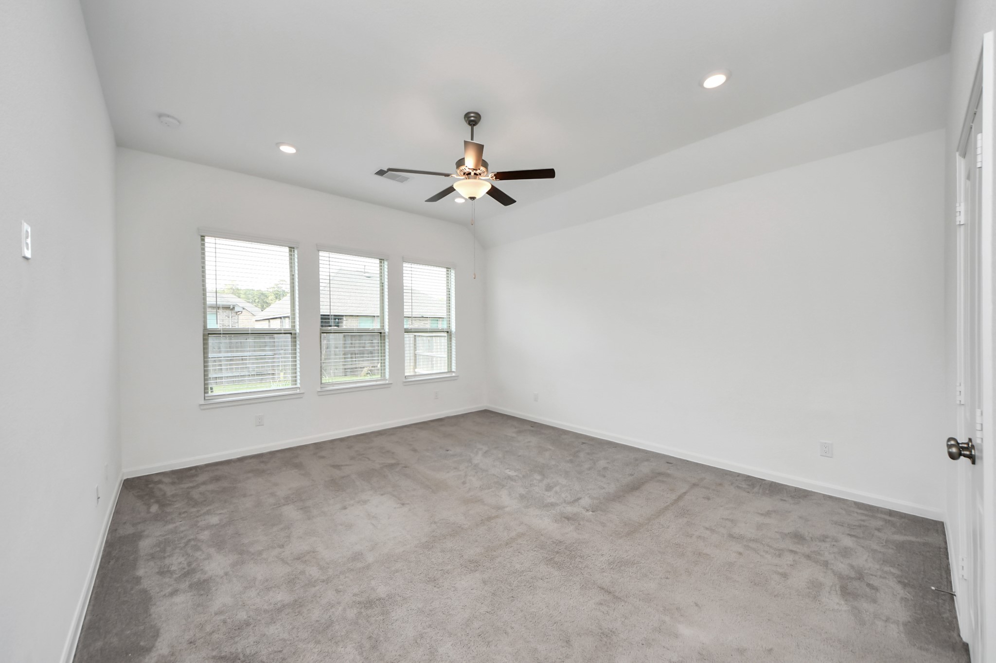 17770 Misty Brook Lane Conroe, TX 77302 - Photo 23 of 50 an empty room with chandelier fan and windows