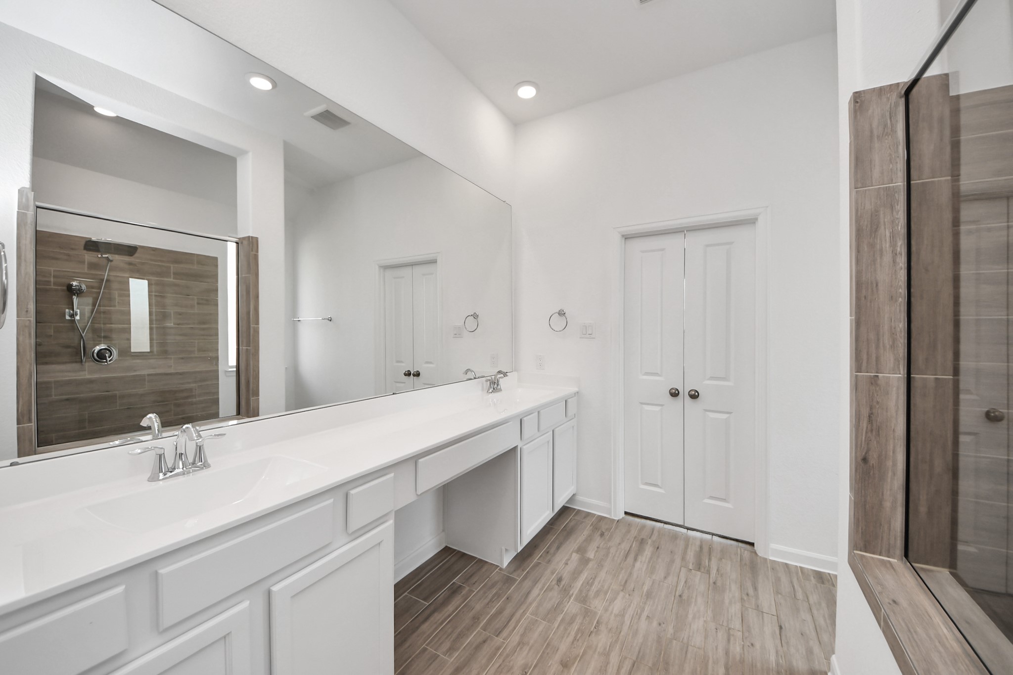 17770 Misty Brook Lane Conroe, TX 77302 - Photo 25 of 50 a bathroom with a double vanity sink a mirror and a shower