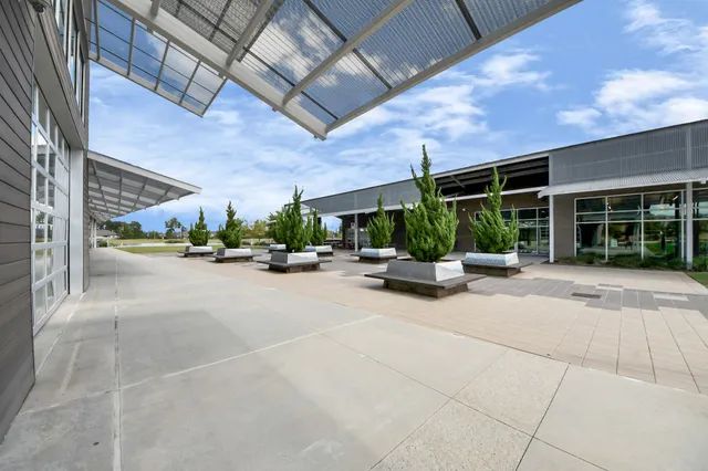 a view of a building with a garden and potted plants