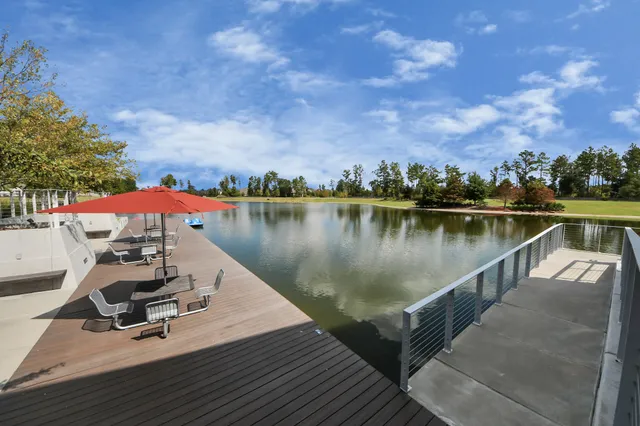 a view of a lake with a table and chairs