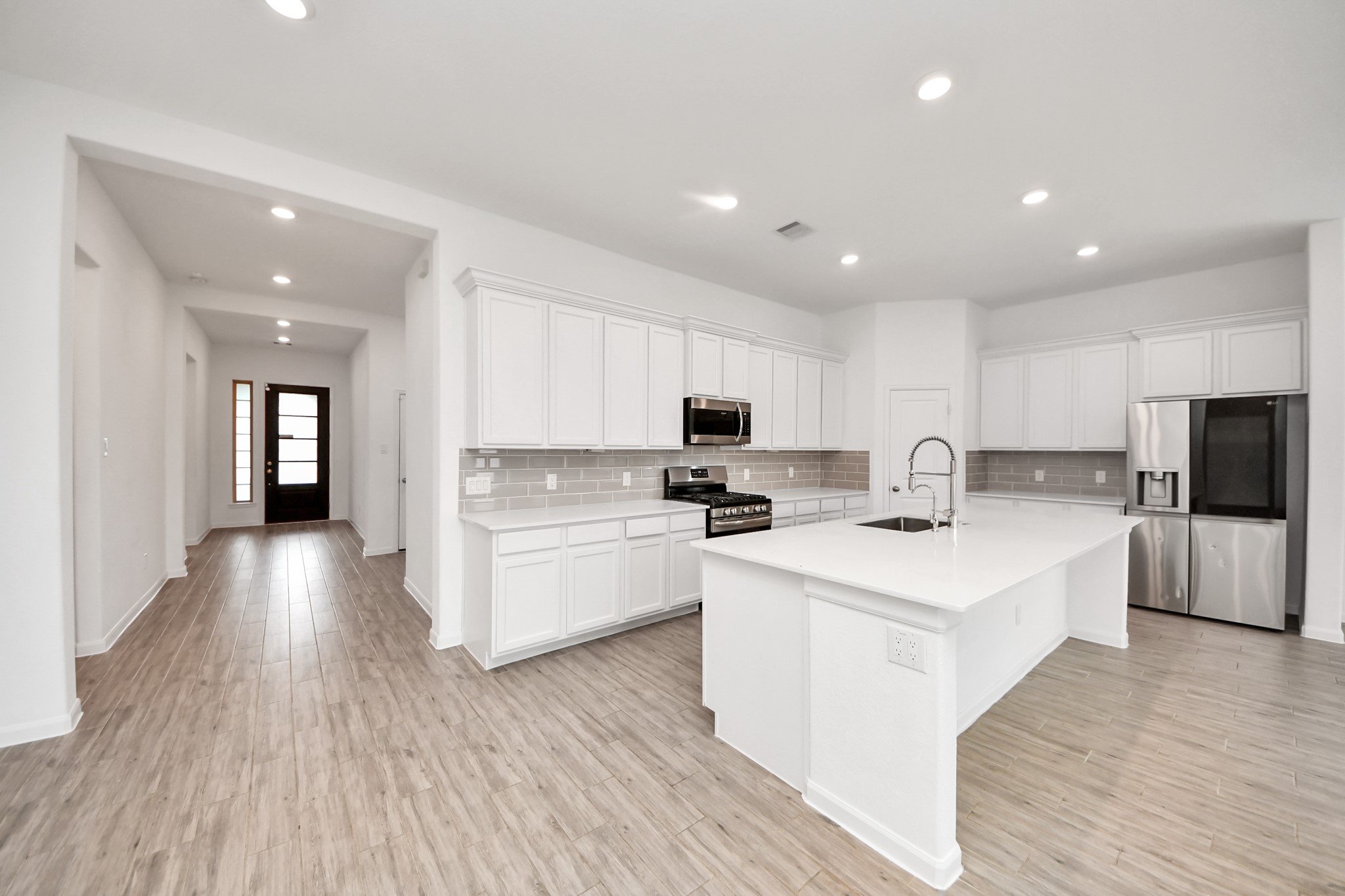 17770 Misty Brook Lane Conroe, TX 77302 - Photo 6 of 50 a large white kitchen with stainless steel appliances