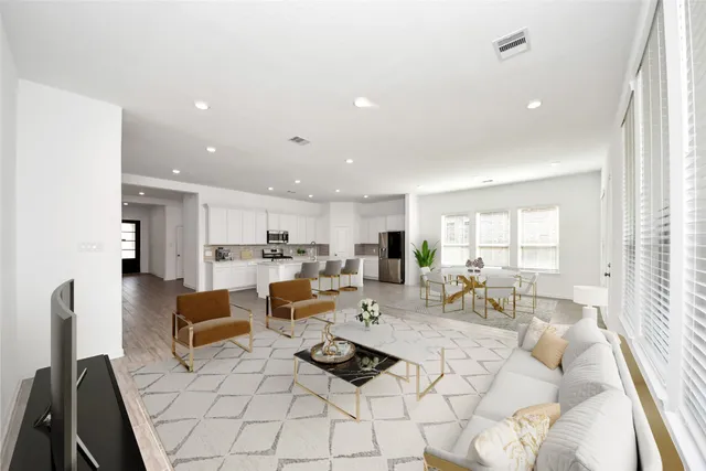 a large white kitchen with stainless steel appliances