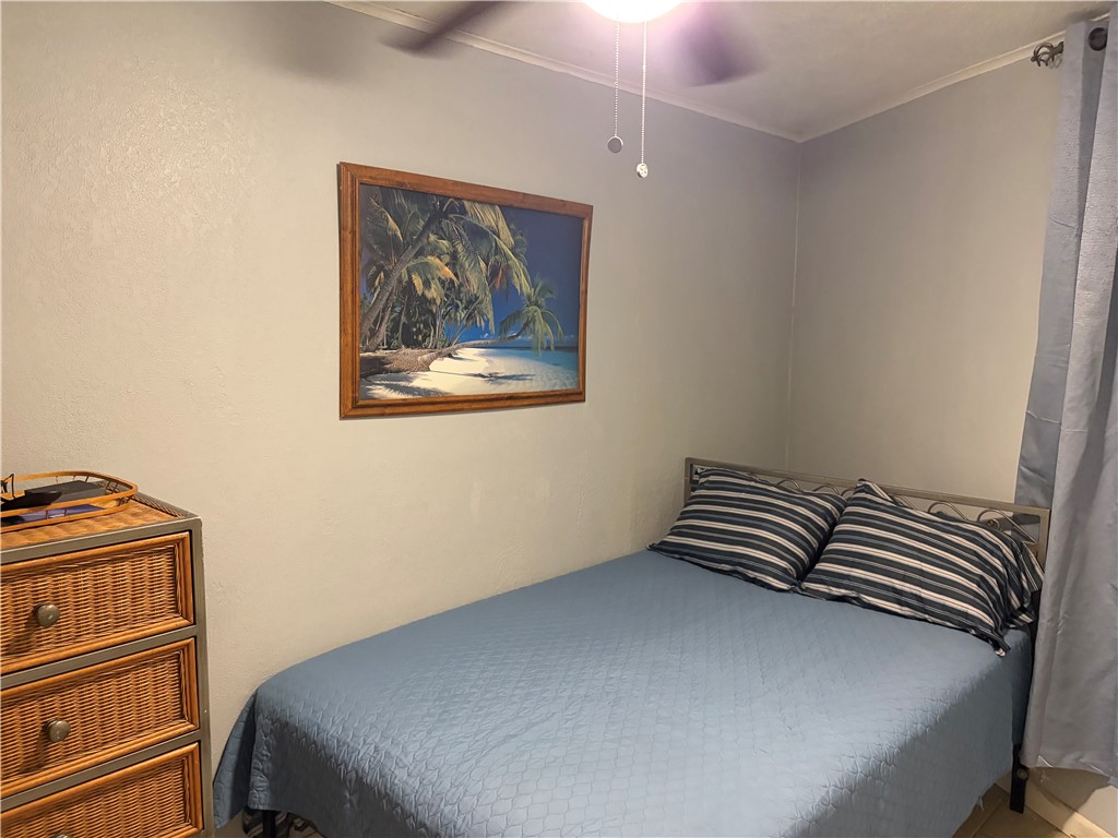 3938 Surfside Boulevard Corpus Christi, TX 78402 - Photo 9 of 12 a bedroom with a bed and a painting on the wall