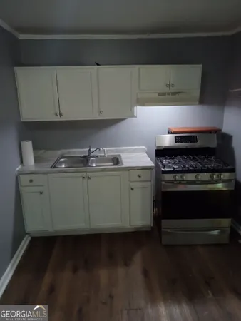 a kitchen with wooden cabinets and a stove top oven