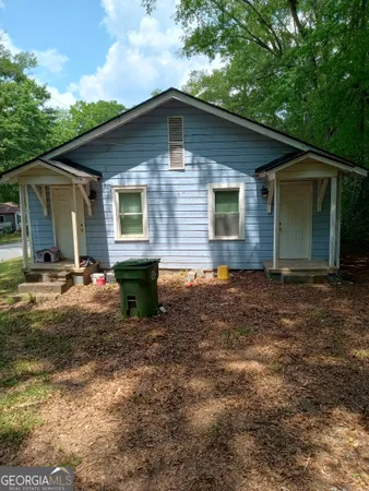 a backyard of a house with yard and barbeque oven