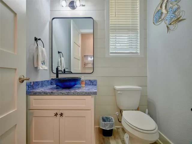 a bathroom with a toilet a sink and mirror