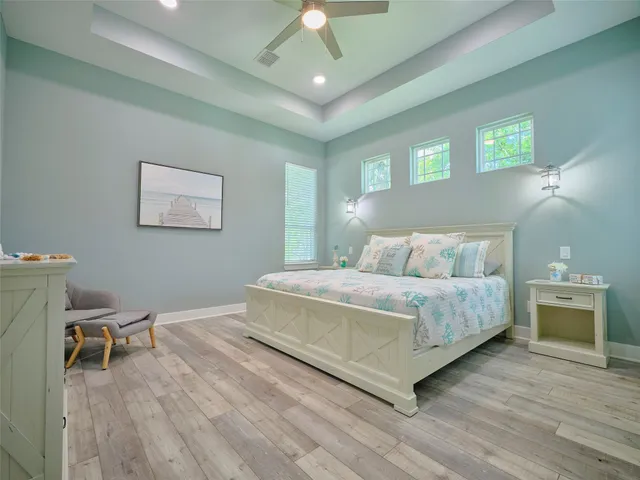 a bedroom with a bed and a chandelier