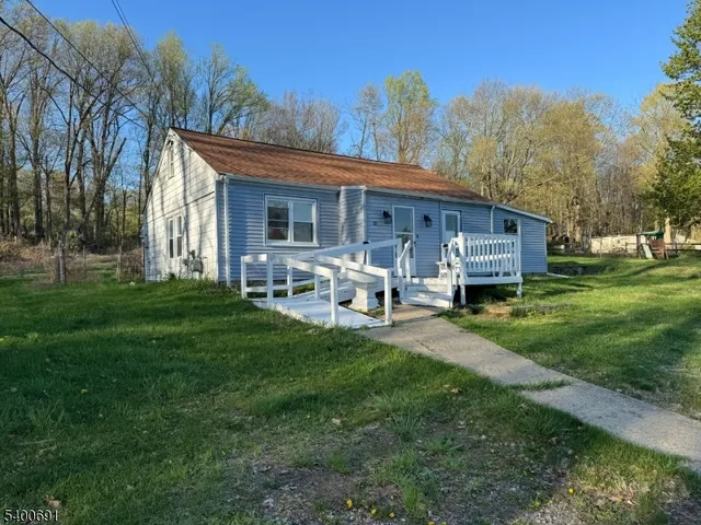 a view of a house with backyard sitting area and garden