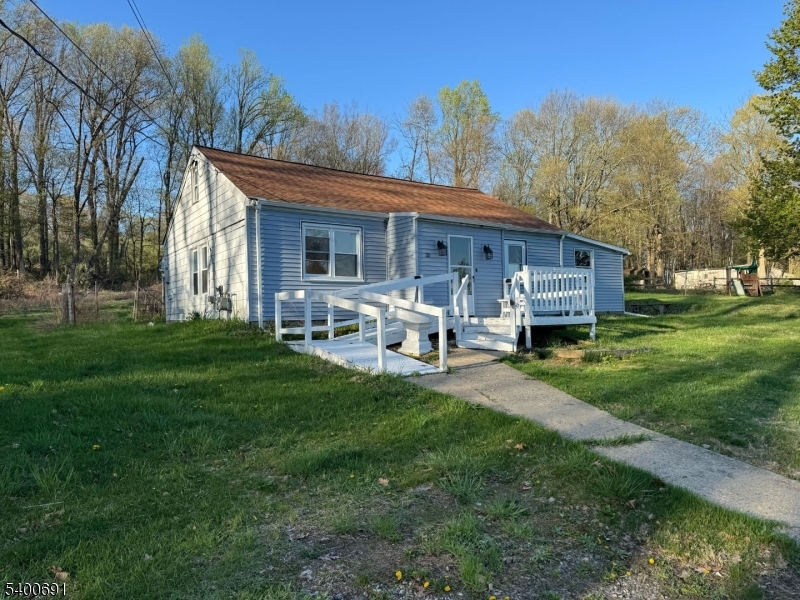 22 Spring Lane Long Valley, NJ 07853 - Photo 1 of 12 a view of a house with backyard sitting area and garden