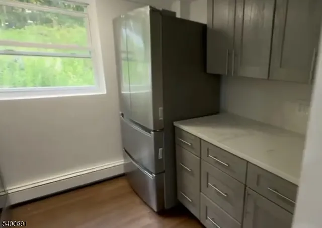 a kitchen with a refrigerator and a window