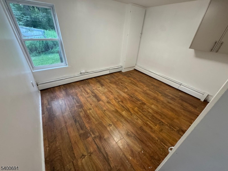 22 Spring Lane Long Valley, NJ 07853 - Photo 6 of 12 an empty room with wooden floor and windows