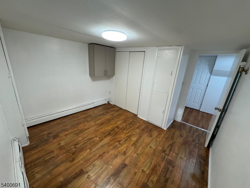 22 Spring Lane Long Valley, NJ 07853 - Photo 7 of 12 a view of empty room with wooden floor and fan