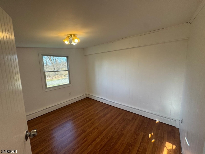 22 Spring Lane Long Valley, NJ 07853 - Photo 10 of 12 an empty room with wooden floor and windows