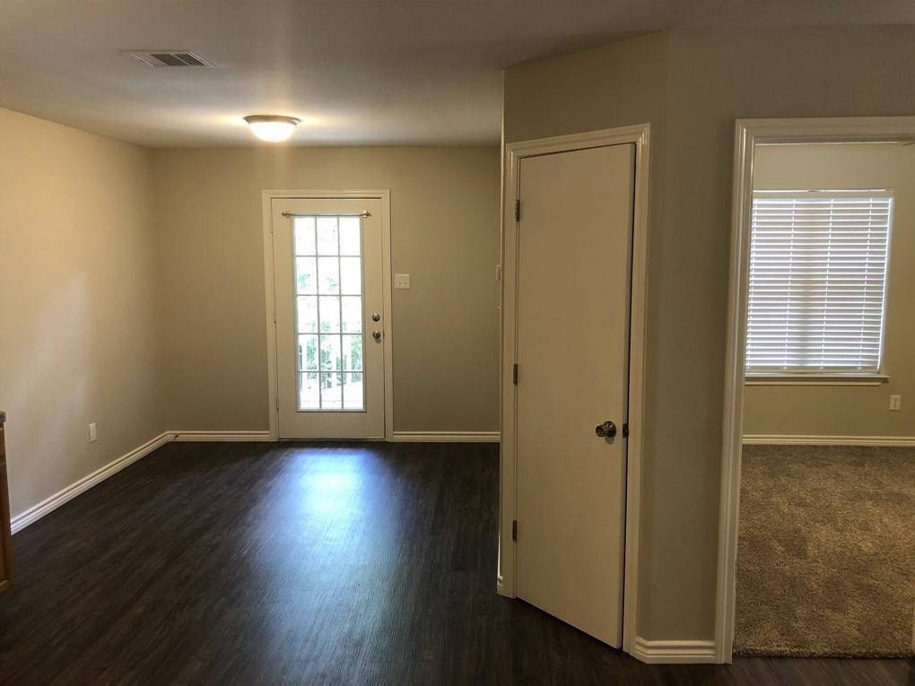 212 Gulf Pump Road, Unit C Crosby, TX 77532 - Photo 2 of 14 a view of an empty room with wooden floor and a window