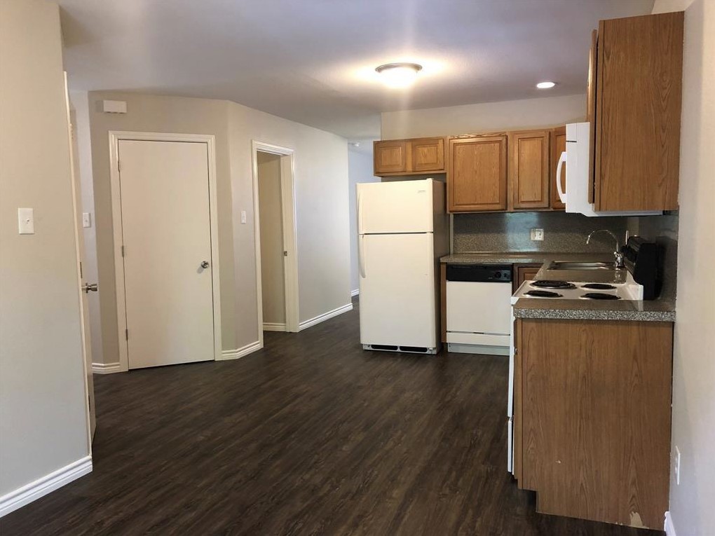 212 Gulf Pump Road, Unit C Crosby, TX 77532 - Photo 3 of 14 a kitchen with a refrigerator a stove and wooden floor