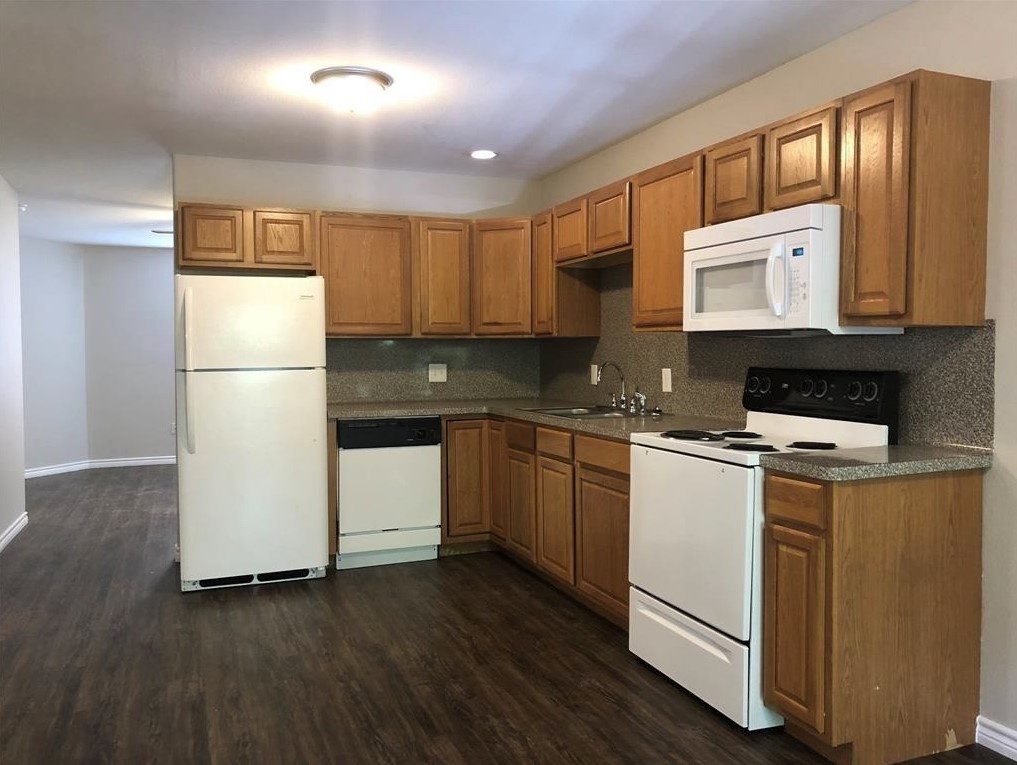 212 Gulf Pump Road, Unit C Crosby, TX 77532 - Photo 4 of 14 a kitchen with a refrigerator a stove top oven a sink and cabinets