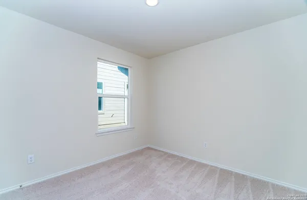 a view of an empty room with windows