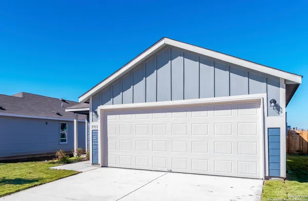 a view of wooden house with a small yard
