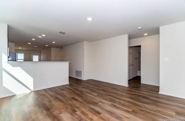 a view of a big room with wooden floor and staircase