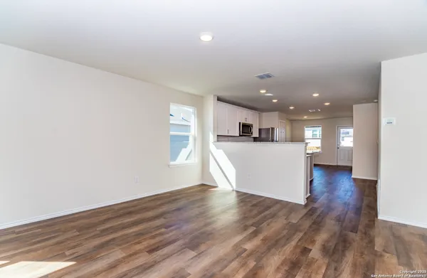 a view of a kitchen with wooden floor and a kitchen
