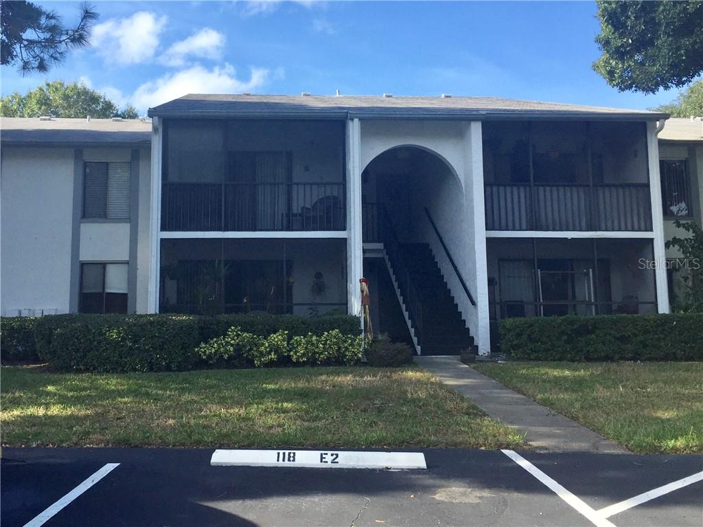 1261 Pine Ridge Circle West, Unit E2 Tarpon Springs, FL 34688 - Photo 1 of 1 a view of a house with a yard