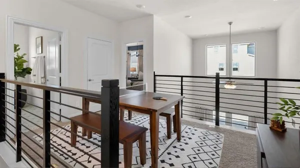 a view of a hallway with dining room and stairs