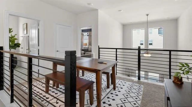 a view of a hallway with dining room and stairs