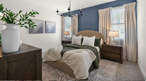 a bedroom with bed and a potted plant