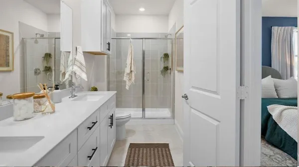 a bathroom with a double vanity sink mirror and shower
