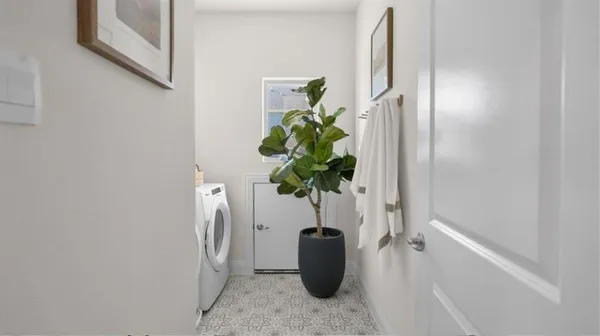 a white vase with white and yellow flowers