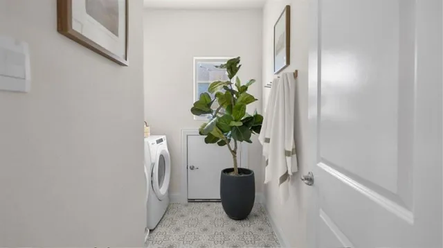 a white vase with white and yellow flowers