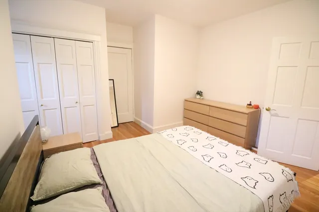 a bedroom with a bed and a cabinets