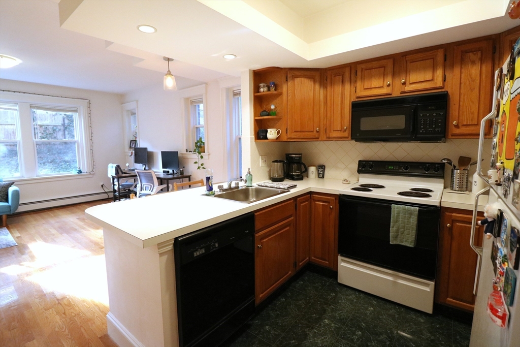 30 Upland Road, Unit 4 Cambridge, MA 02140 - Photo 5 of 14 a kitchen with a sink a stove and microwave