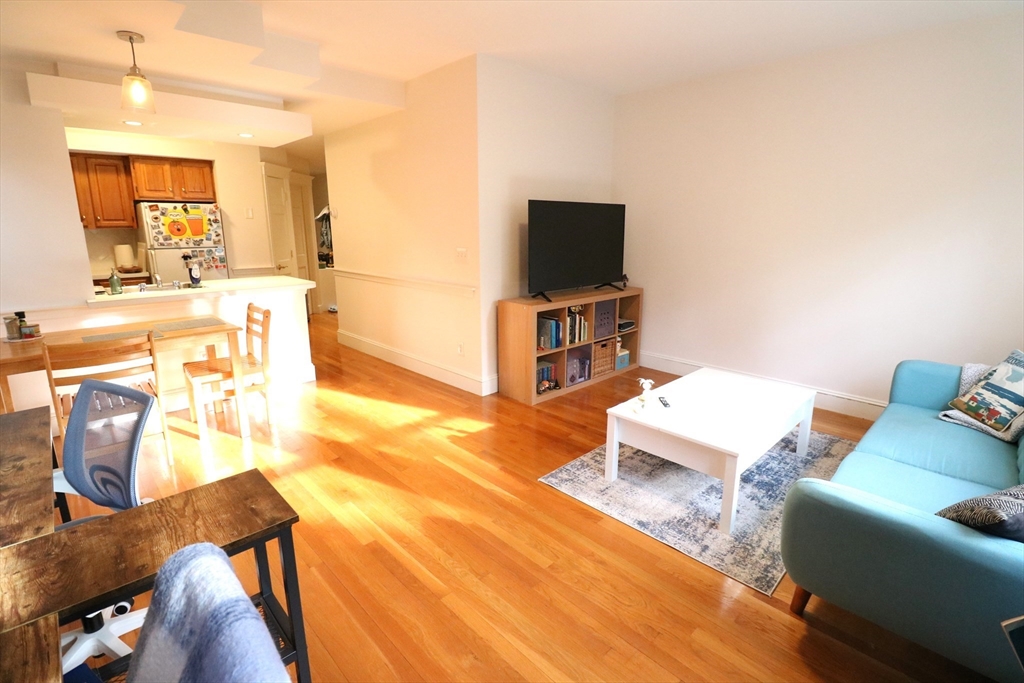 30 Upland Road, Unit 4 Cambridge, MA 02140 - Photo 8 of 14 a living room with furniture and a flat screen tv