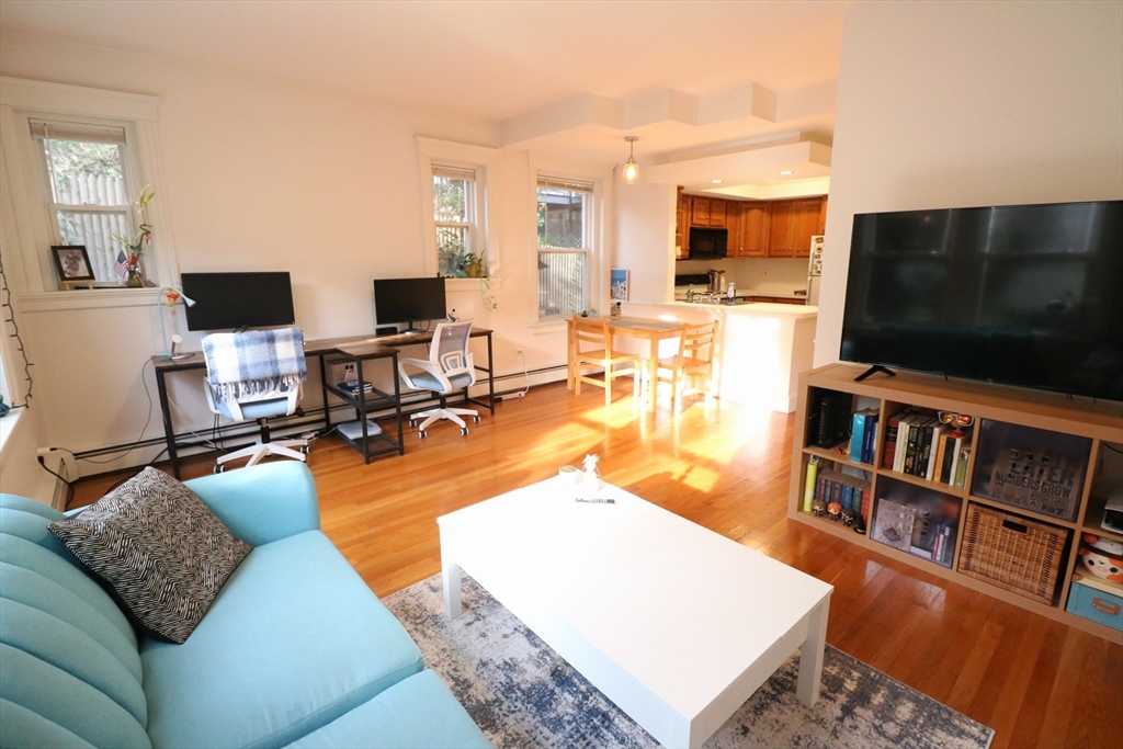 30 Upland Road, Unit 4 Cambridge, MA 02140 - Photo 9 of 14 a living room with furniture and a flat screen tv
