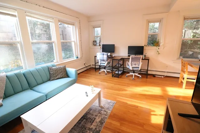 a living room with patio furniture and a large window