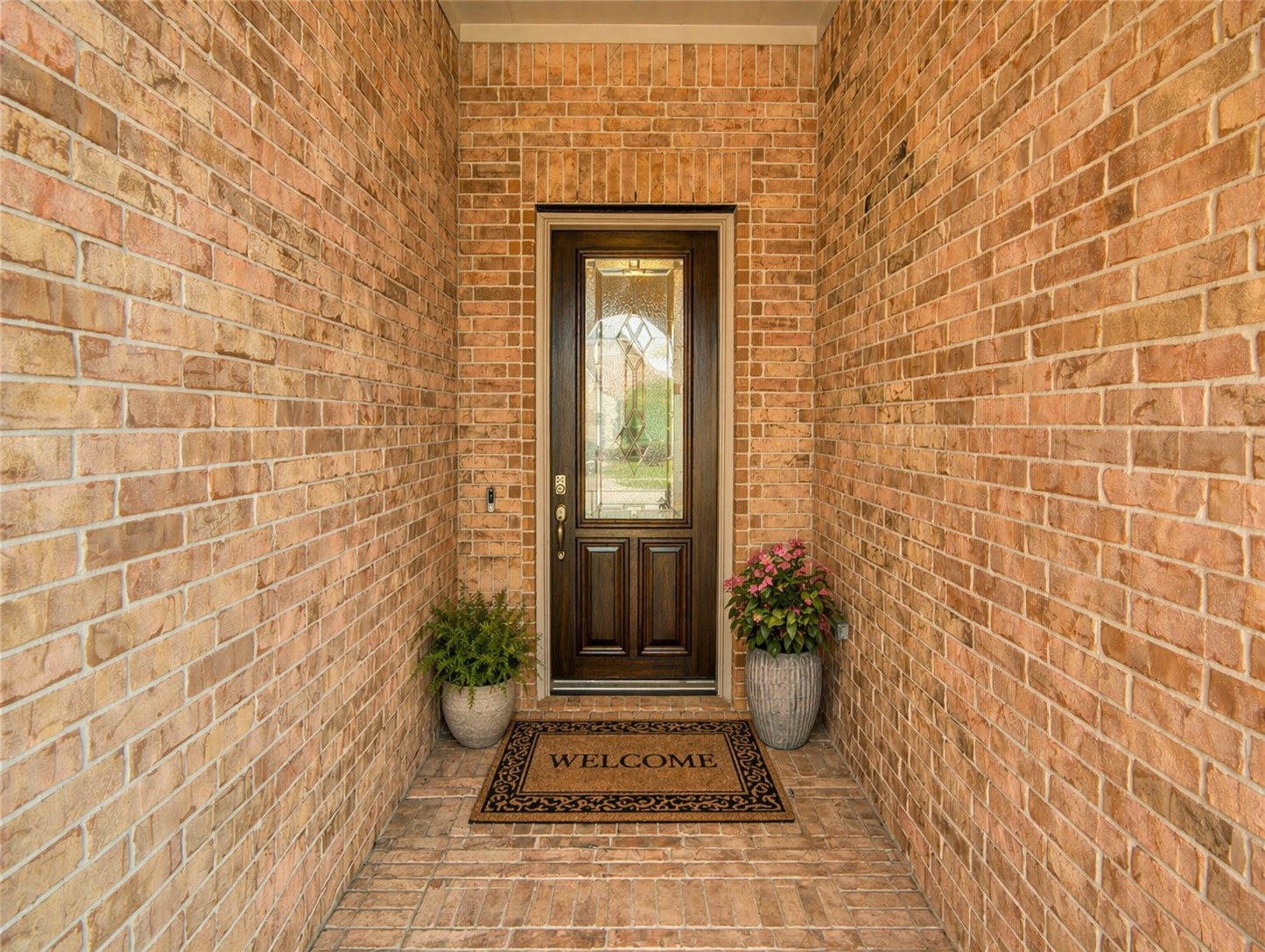 1314 Orchard Ridge Lane Tomball, TX 77375 - Photo 5 of 35 The covered front entry with detailed brickwork and a glass-paneled door sets the tone for a bright and welcoming interior.